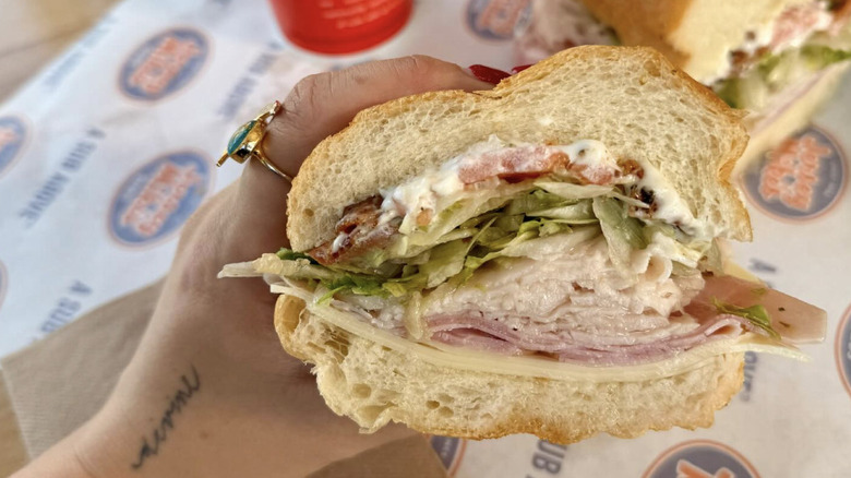 Person holding Jersey Mike's sub with mayonnaise