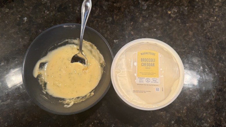 Bowl of broccoli cheddar soup beside packaging
