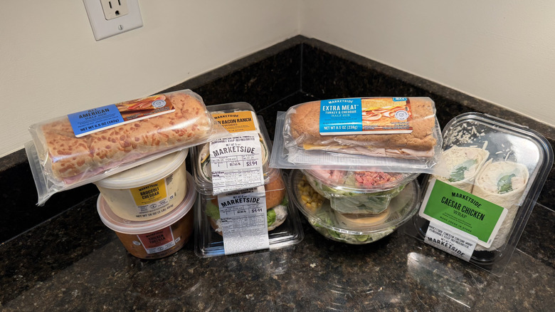 Variety of Walmart Marketside prepared foods on black counter