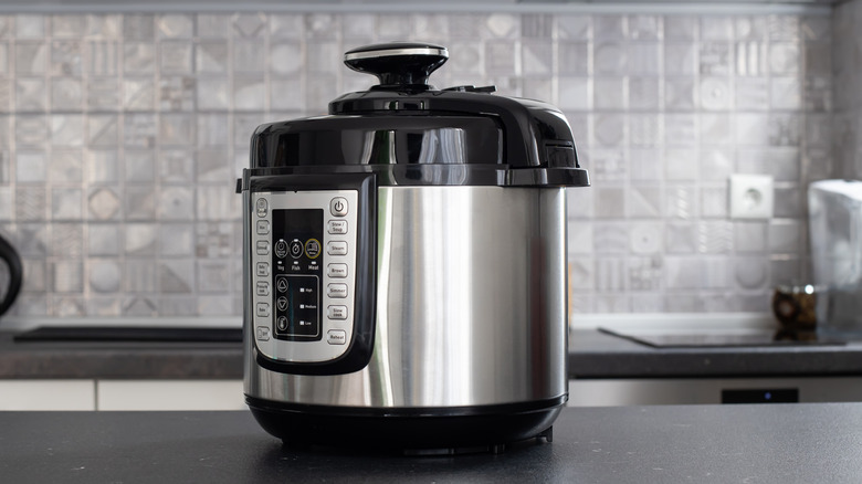 A pressure cooker sitting on a kitchen counter