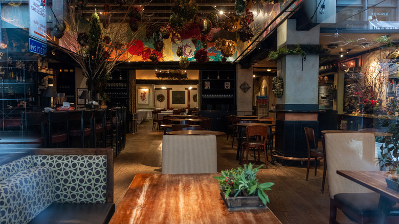 The tavern room at Gramercy Tavern has hardwood floors, tables, and chairs.