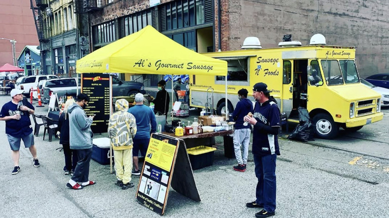 Group of customers standing outside of Al's Gourmet Sausage tent