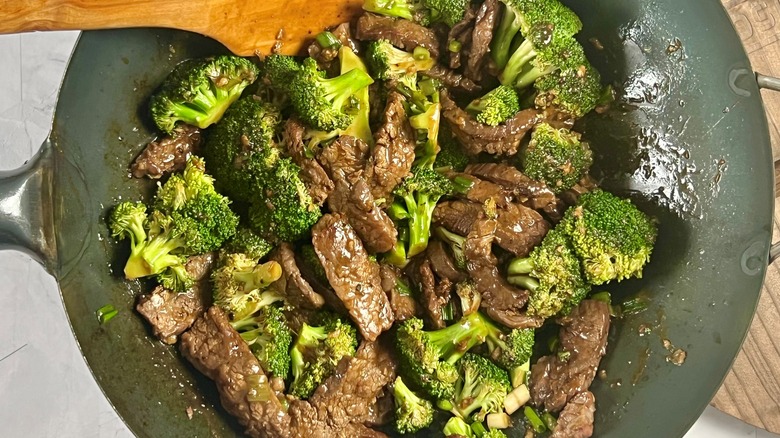 beef and broccoli in wok