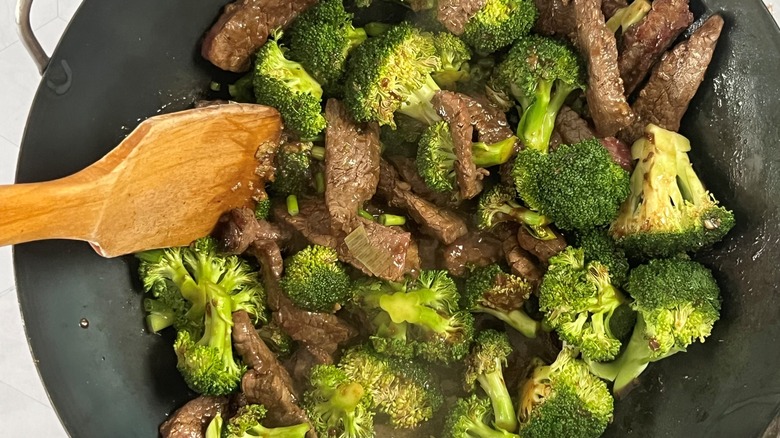 beef and broccoli in wok