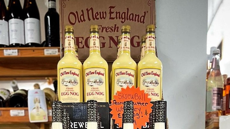 Four bottles of Old New England eggnog on display in a store