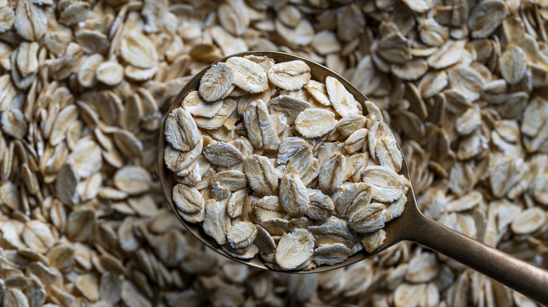 Close-up of wooden spoon scooping oats