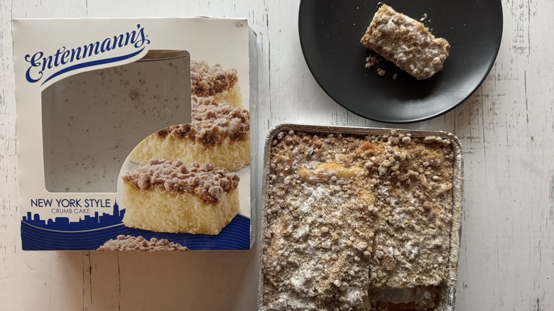 Whole coffee cake and slice on white background