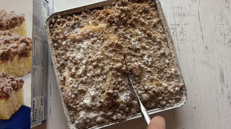 Person slicing into coffee cake