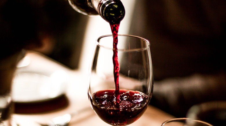 Red wine pouring into glass