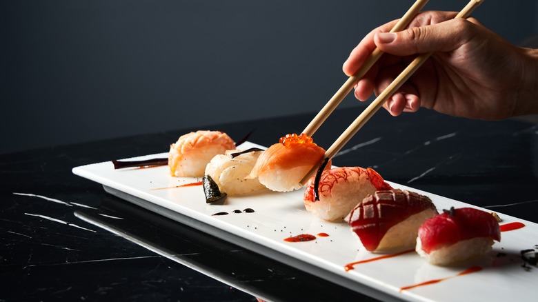 Six nigiri on white plate