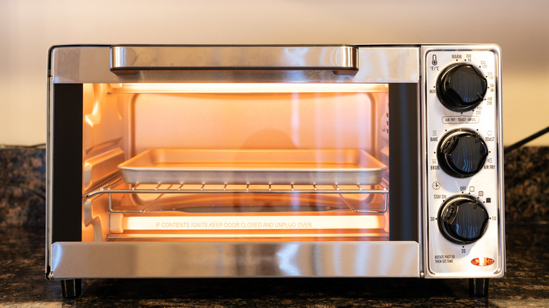 A toaster oven with lights is on a kitchen counter