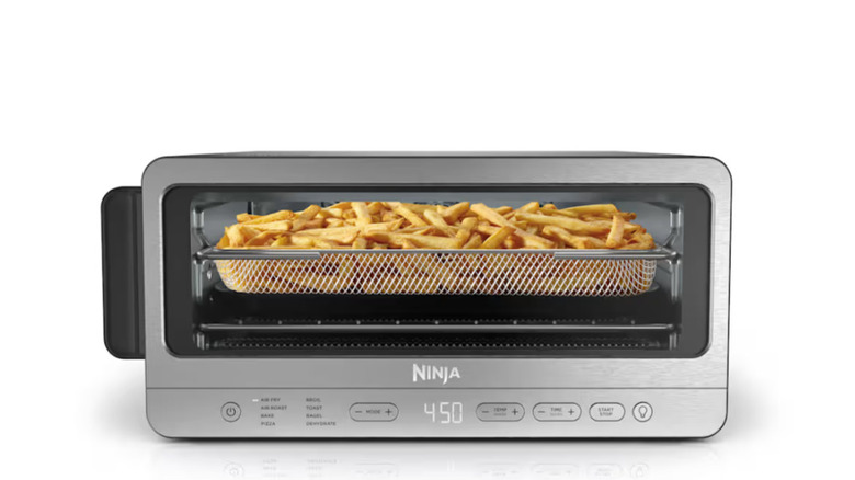 A Ninja Flip Toaster Oven and Air Fryer is filled with french fries