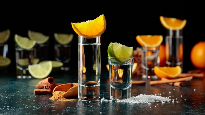 Shots of tequila with lime, orange, salt, and spices