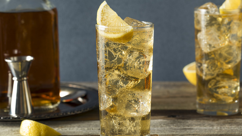 Whiskey highball with ginger ale, ice, and a wedge of lime