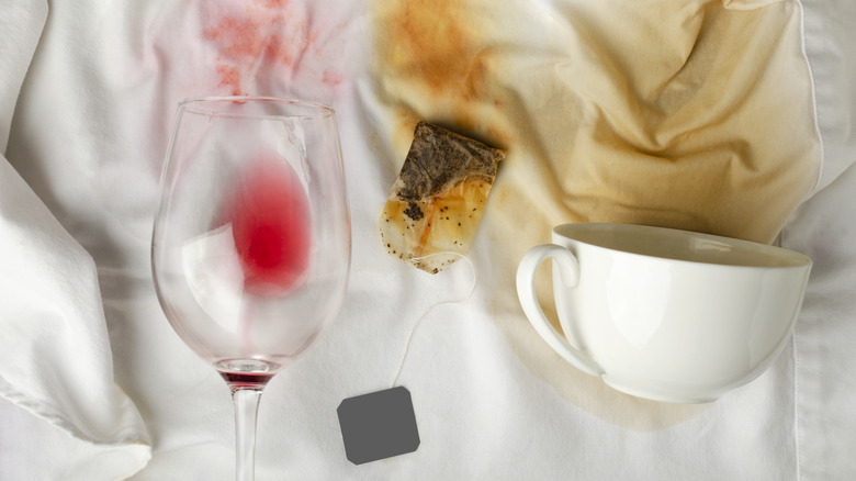 A white fabric stained with red wine, tea, and coffee