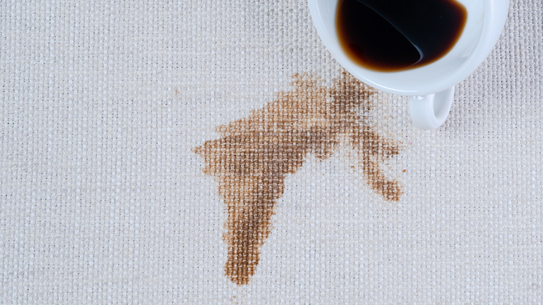 A coffee stain on a white tablecloth.