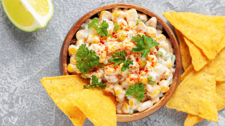 Esquites with chips and a lime