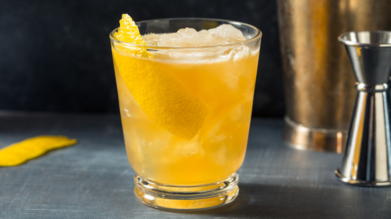 A Gold Rush cocktail with lemon peel garnish