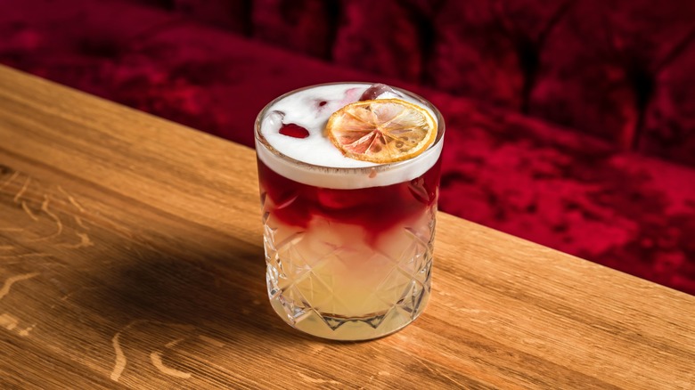 A New York sour cocktail on a wooden tabletop.