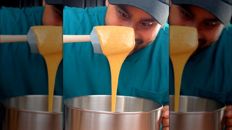 A spatula dripping whipped honey.