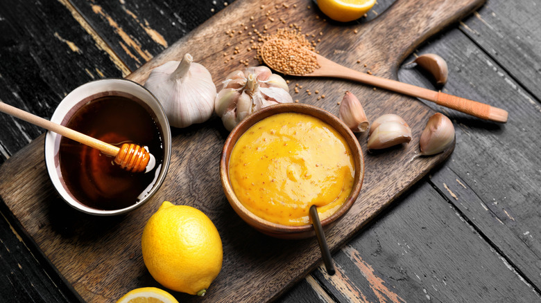 Bowl of honey and bowl of honey mustard sauce.