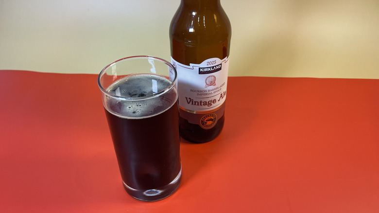 A glass of Kirkland Signature Vintage Ale next to the bottle