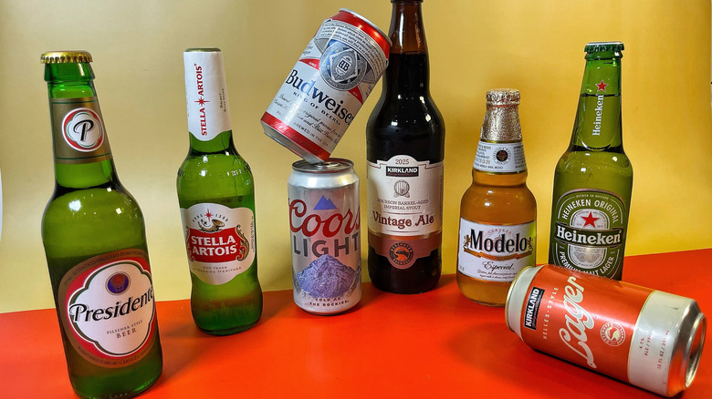 Several beers from Costco arranged on a red and tan background