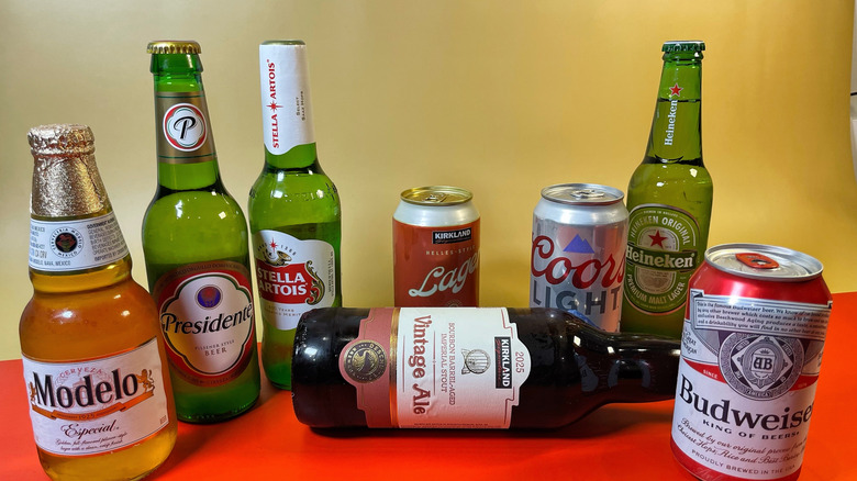 Several beers from Costco arrange on a red and tan background