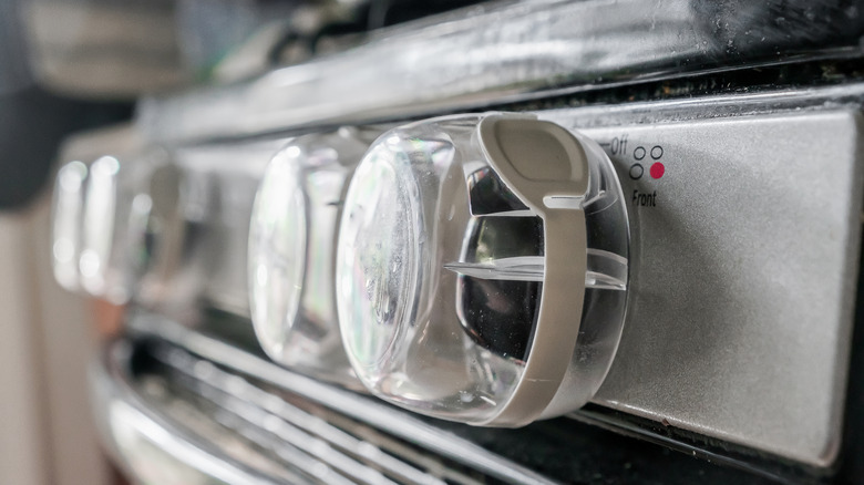Gas stove knobs with childproofing