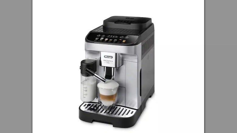 An espresso machine frothing milk