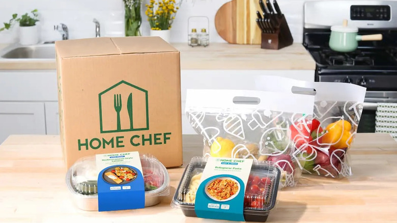 Closed HomeChef delivery box next to ingredients from HomeChef
