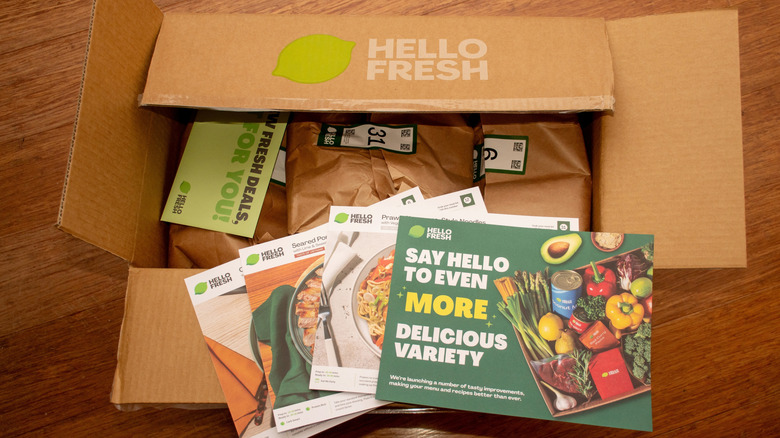 Box from HelloFresh with recipe cards laying on top