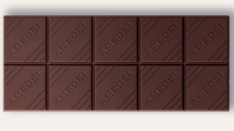 Unwrapped bar of Amedei Toscano Black 63% on a white isolated background