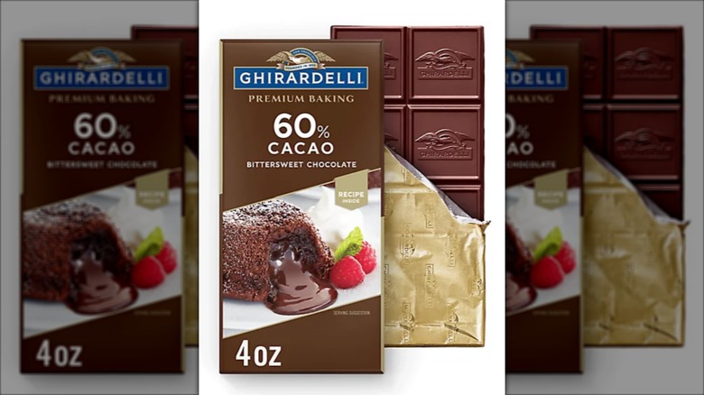 A half unwrapped bar of Ghirardelli 60% cacao baking chocolate next to bar packaging with mirror borders