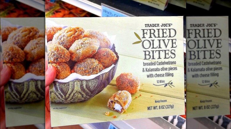 Hand holding a box of Trader Joe's frozen fried olive bites