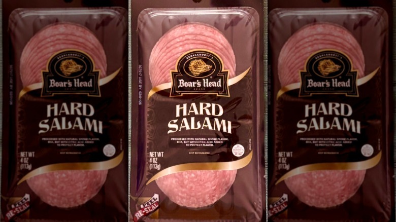 A package of Boar's Head Hard Salami resting on a green tablecloth