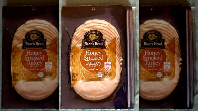 A package of Boar's Head Honey Smoked Turkey Breast resting on a green tablecloth