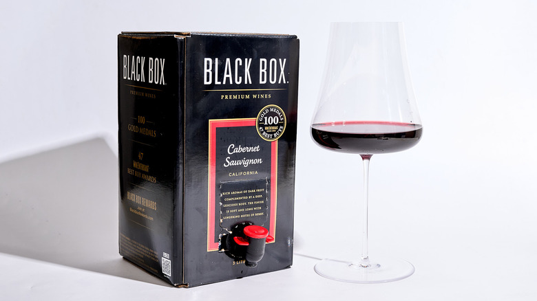 black box on a table with a glass
