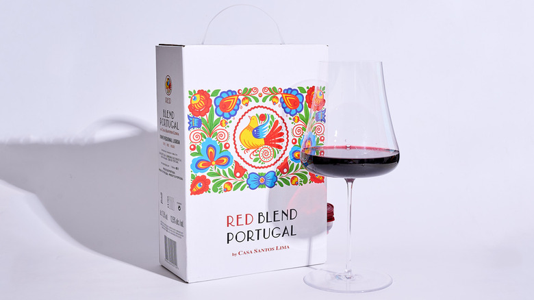 casa santos box on a table with a glass