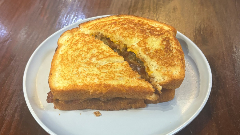 Walburgers super melt burger on a white plate on a wooden table