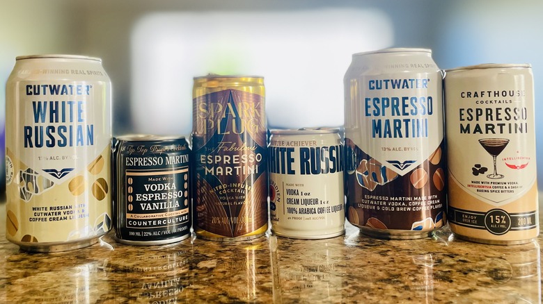 Various canned coffee cocktails lined-up on a marble counter