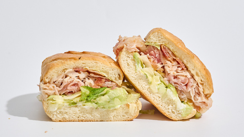 Firehouse club sub sliced in half on a table.