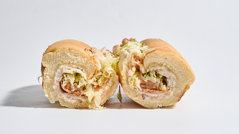 Jimmy John's club sub sliced in half on a table.