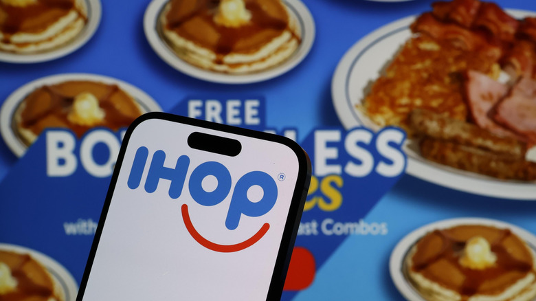 A photo of IHOP's Bottomless Pancakes promo with a smartphone