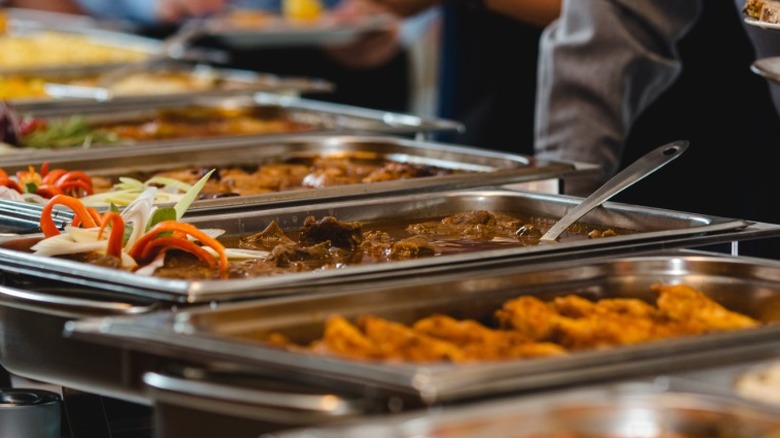 A full buffet with customers or chefs in line