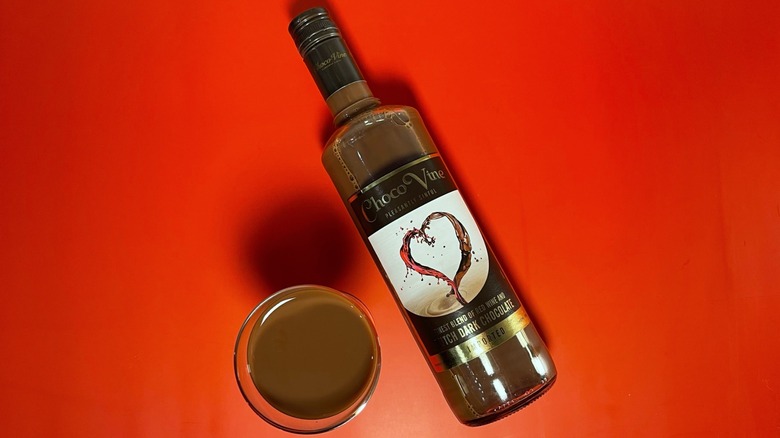 A bottle of dark chocolate ChocoVine on a red background