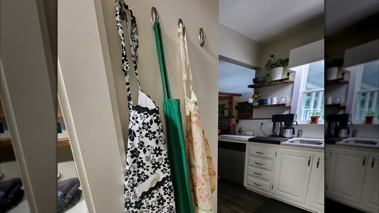 Aprons hanging on command hooks in a kitchen entryway