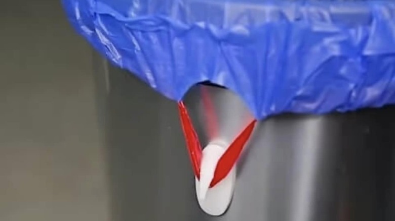 Trash bag tie looped around a Command hook