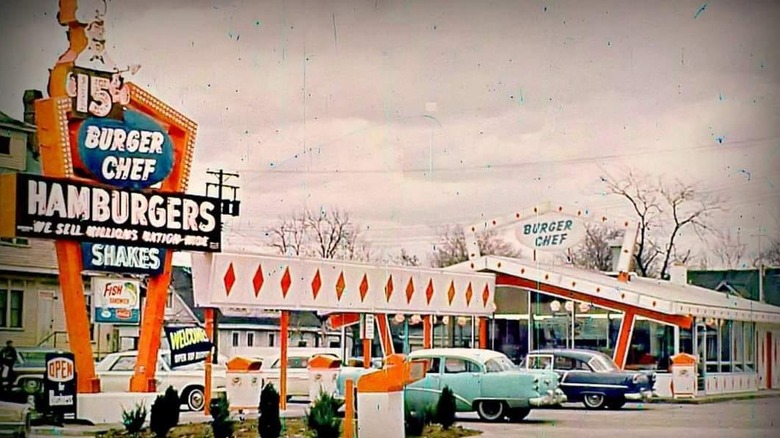 An old photo of a Burger Chef sign in the parking lot outside the drive-thru