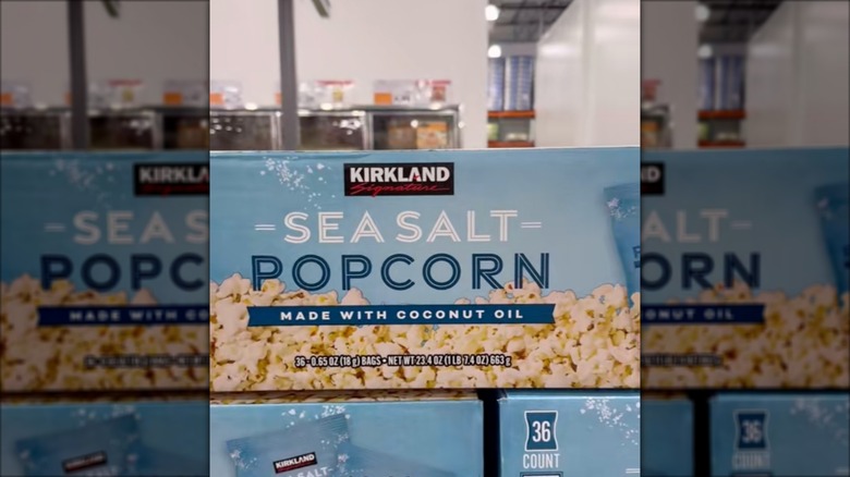 Boxes of Kirkland Signature brand popcorn stacked at Costco